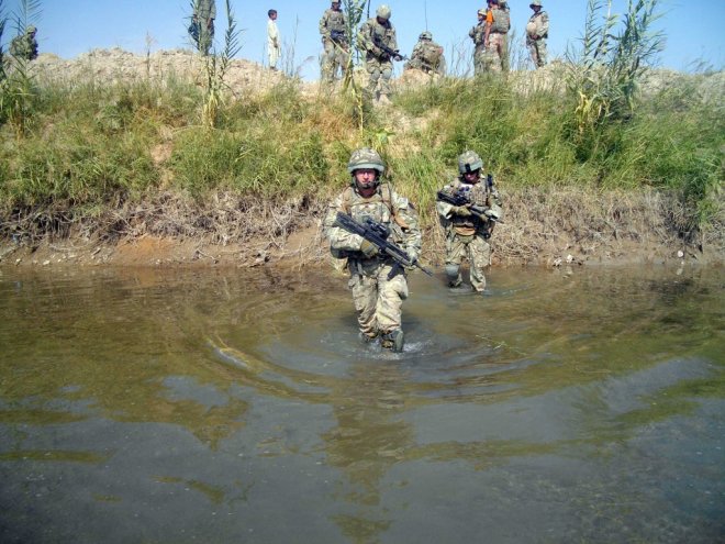 LCpl Jallow and 2Lt Laybourne cross a river during Op Tora Ghar 9.
